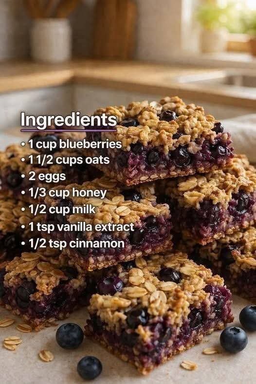 Soft juicy blueberry filled oat bars cut into squares on a plate